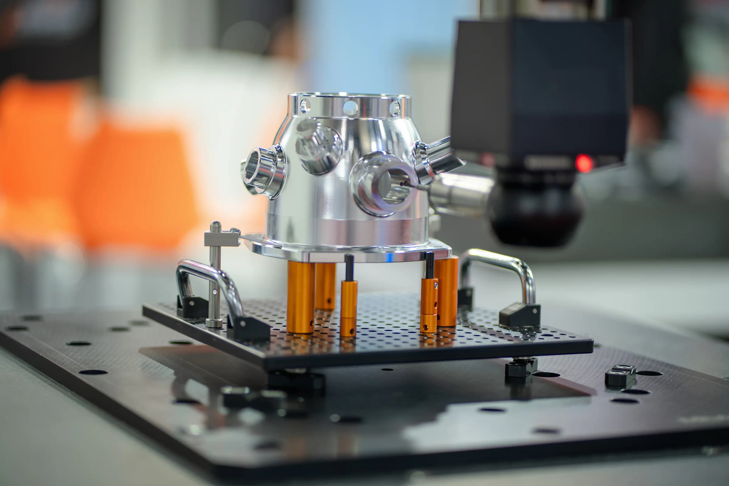 A precision-machined metal component is inspected in a measuring fixture.