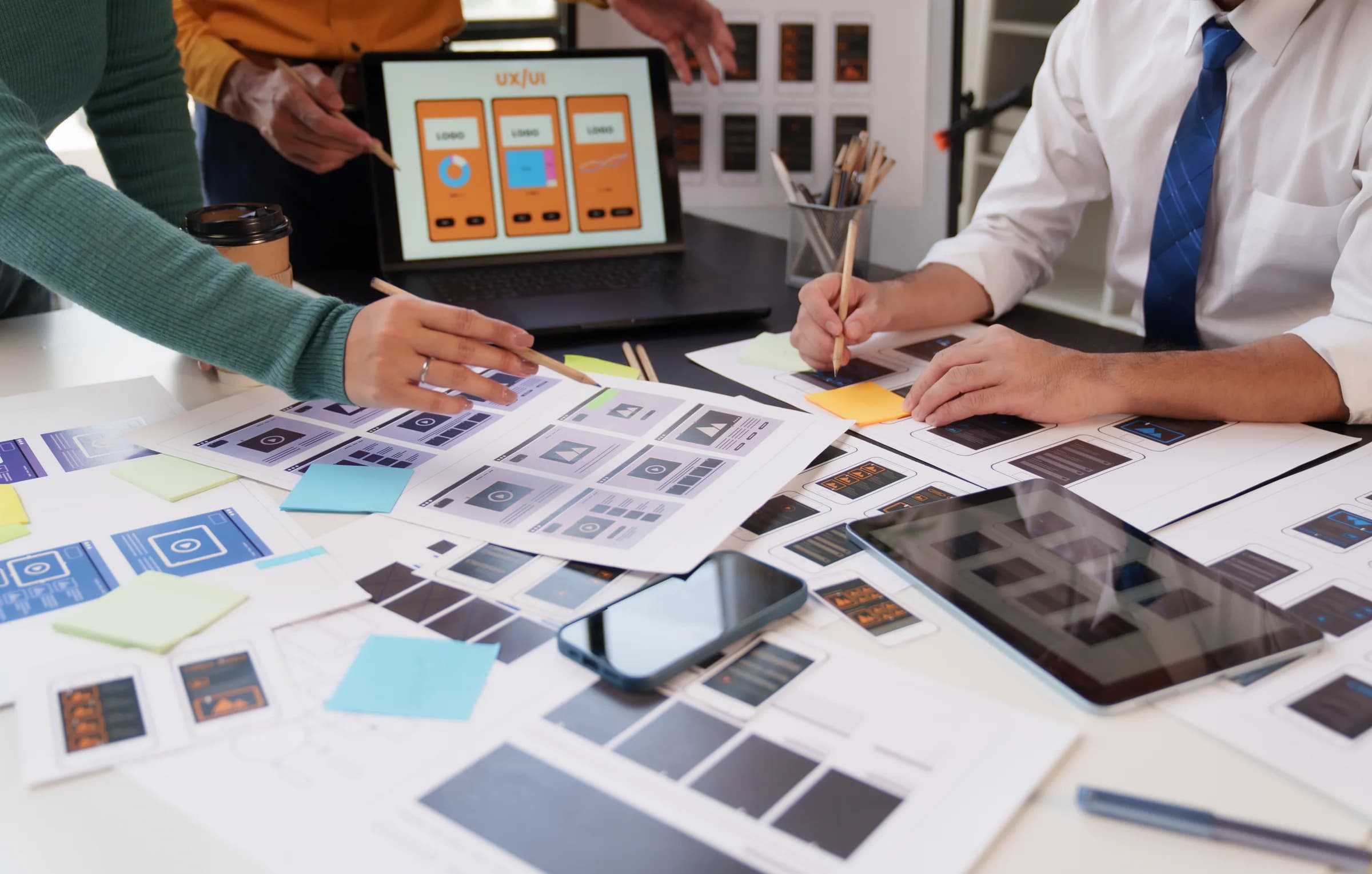 A product team works with wireframes for a digital application.
